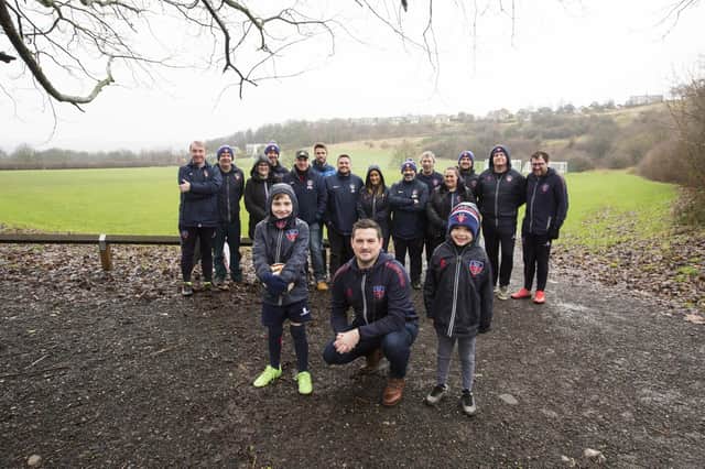 Rastrick Juniors Football Club celebrates funding for new facilities, Carr Green playing fields. Bobby Boskic, nine, chairman Martin Ford and Noah Cooper-Smith, six, with coaches.