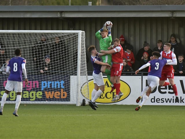 Jake Day challenges the Grantham Town keeper Jim Pollard