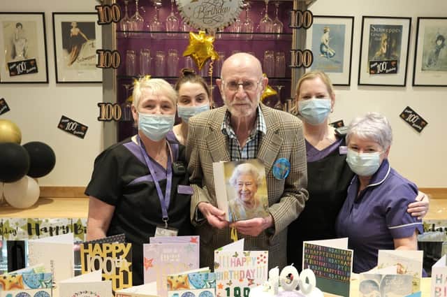 Edmund Sykes with Angelcare staff and his card from the queen