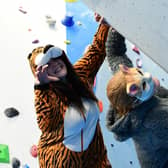 RSPCA's Lauren Moore (orange cat suit) and Michelle King (cat mask) test out the climbing at ROKT in Brighouse ahead of their fundraiser.