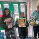 Andrew Bateman from Rotary Halifax Calder with staff from Ash Green Primary School and the donated books.