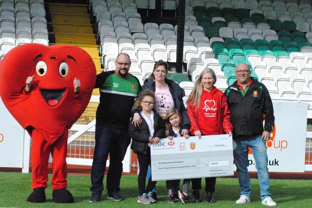 West Bowling ARLFC and family of Lee Hunter present the British Heart Foundation with a cheque for their most recent fundraising event, which raised £3,500. Pictured from left to right; The charity's mascot Mr Hearty, Paul Robertson, Carly-Jo Miller, Poppy Hunter, Indie Hunter, Ellie Barker and Dave Brook. Photograph taken by Lisa Camden.