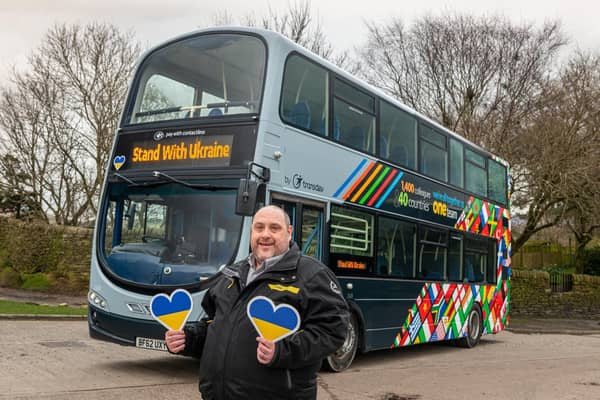 Michael Ridings, driver at Transdev, with the new Ukrainian flag hearts being posted on all of Transdev buses across the north of England