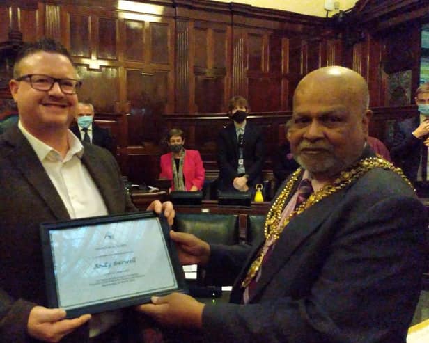Calderdale Council staff member Andy Barwell, left, receiving his certificate of commendation for his actions from the Mayor of Calderdale, Coun Chris Pillai,