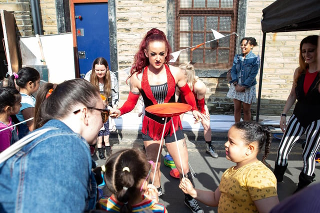 Children learn how to spin plates at Brighouse Open Market fun day
