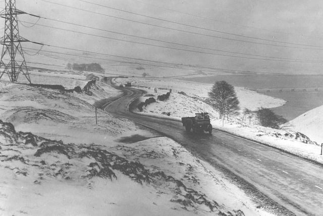 A lone lorry on the bleak Halifax-Rochdale Road near Baitings Reservoir, Ripponden, during a very snowy spell in 1960.