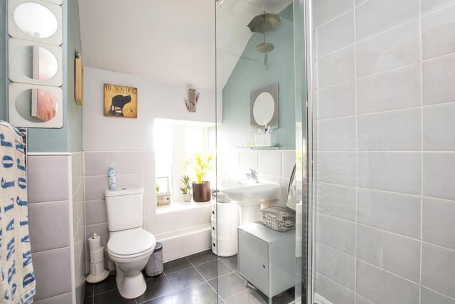 This mainly tiled shower room adds one of many modern conveniences to the Listed property.