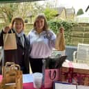 Christine Gow and her daughter Imogen handing out cream teas and selling raffle tickets]