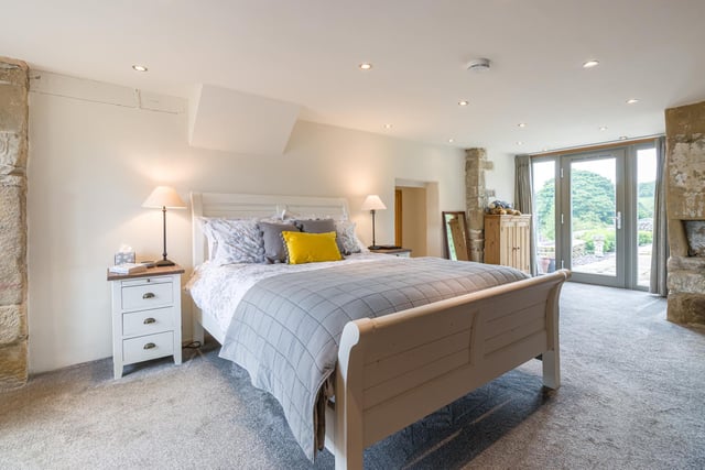 A door leads outside to the gardens from this spacious bedroom.