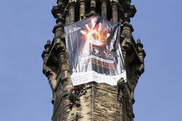 Firefighters launch the moor fire awareness campaign with a banner on Wainhouse Tower, Halifax. Abseiling firefighters Dave Haigh, left, and Ash Harris, right.