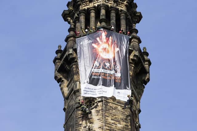 Firefighters launch moor fire awareness campaign with a banner on Wainhouse Tower, Halifax. Abseiling firefighters Dave Haigh, left, and Ash Harris, right.