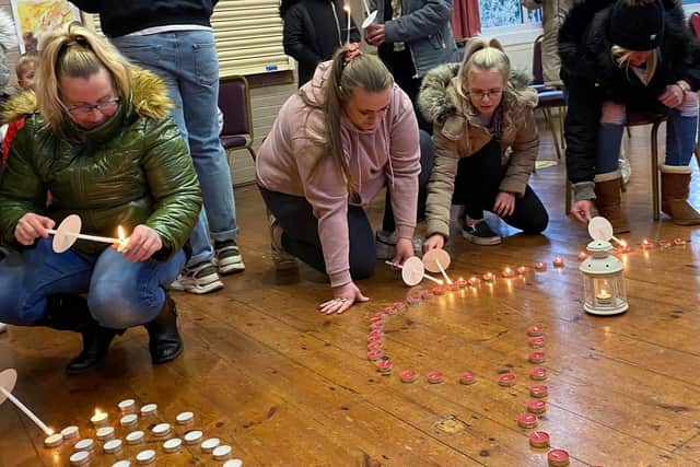People laid out candles at the vigil