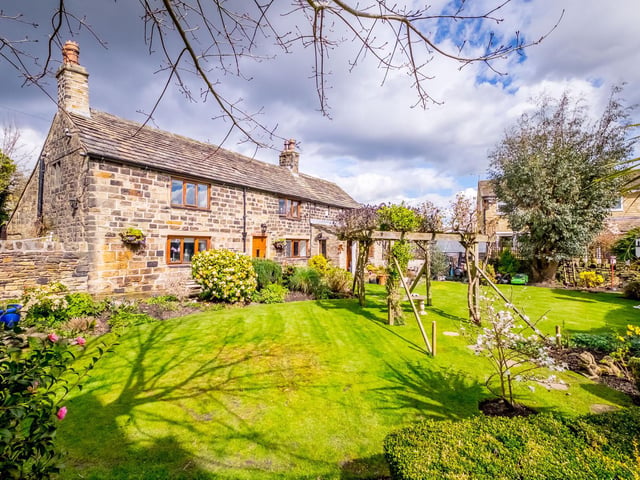 The pleasing aspect of the stone built farmhouse and its garden.