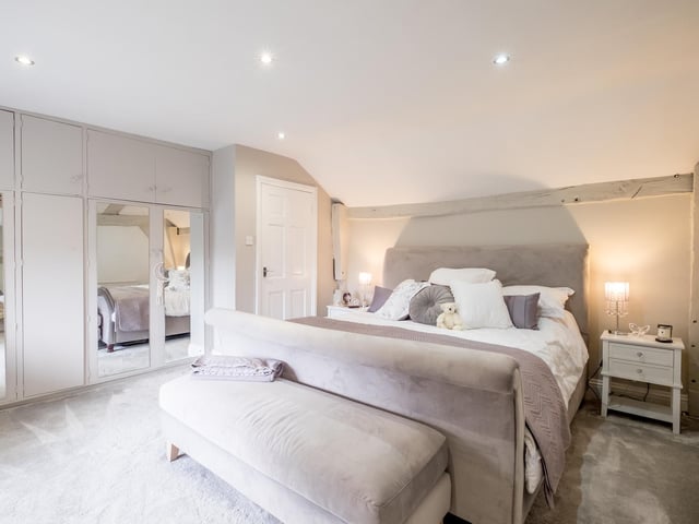 One of the spacious bedrooms with a range of fitted wardrobes.