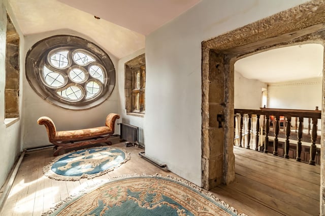 The circular window on the first floor, with stone framed doorway to the gallery landing.