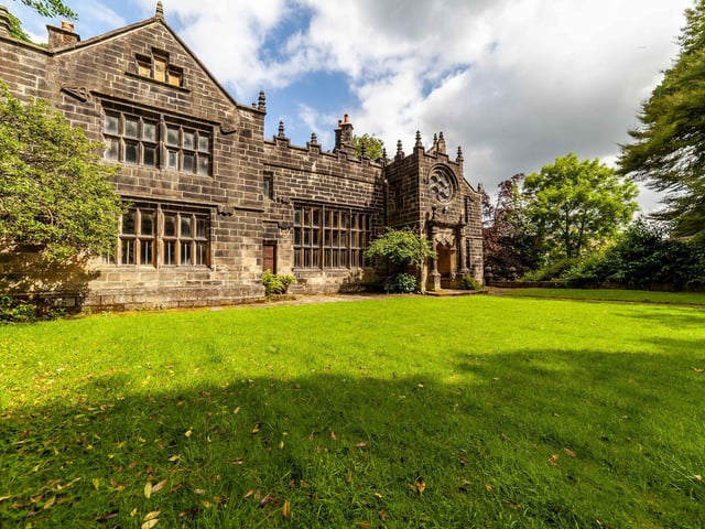 An alternative view of the lovely building that is surrounded by trees and garden.