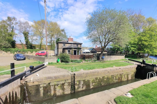 A clear view of the leafy surroundings, with the canal, around the cottage.