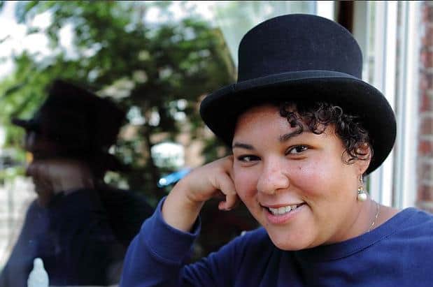 Sami at home wearing a top hat inspired by Anne Lister in Gentleman Jack