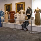 Richard Mcafarlane and Elinor Camille-Wood prepare the displays for Fashion in Anne Lister at the Bankfield Museum