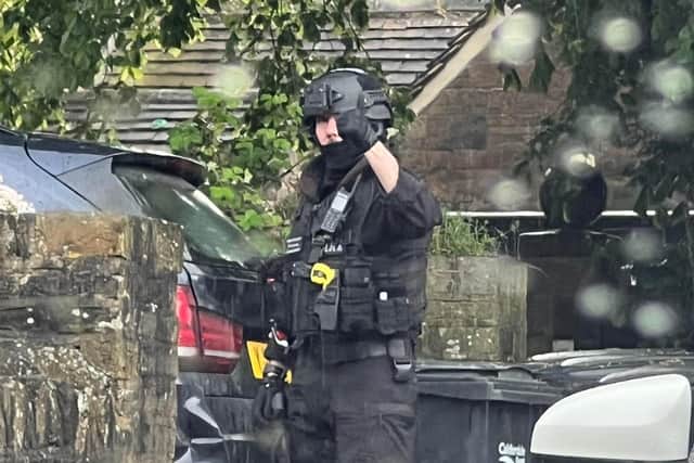 An armed officer in Skircoat Green in Halifax earlier today. Photo by Createch Interiors Ltd