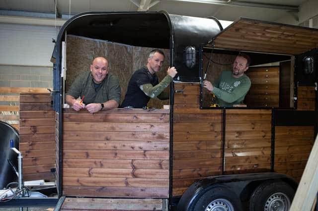 Chris Blackburn, Ross Hallam and Chris Illingworth, Halifax school friends setting up a bar using an old horse trailer