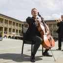 Conductor Ben Crick (playing the cello) and trumpet player Anthony Thompson, both of the Yorkshire Symphony Orchestra at The Piece Hall