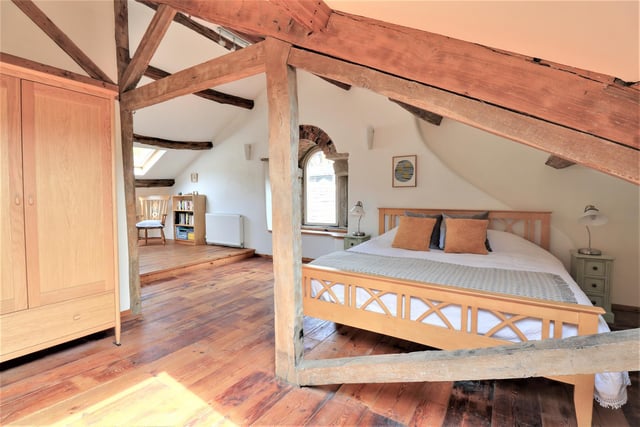 A huge amount of space in this characterful bedroom with open vaulted ceiling and beams.