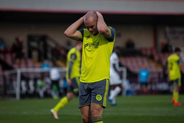 Josh Staunton looks dejected as Town bow out at Boreham Wood in 2020. Photo: Marcus Branston