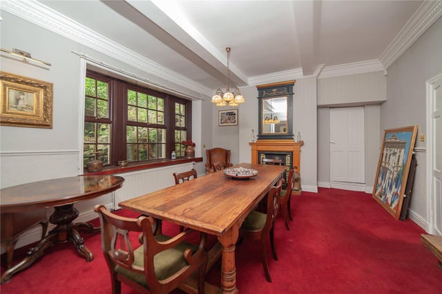 Here there is space for a large dining table and chairs, with a fireplace and sizeable windows adding to the room's character.