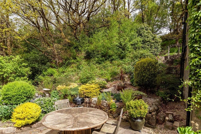 An area in which to dine al fresco within the tiered rear garden.
