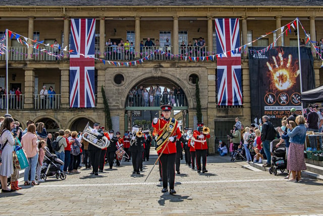 West Yorkshire Fire Service and West Yorkshire Police bands march into The Piece Hall to perform the national anthem. Picture Tony Johnson