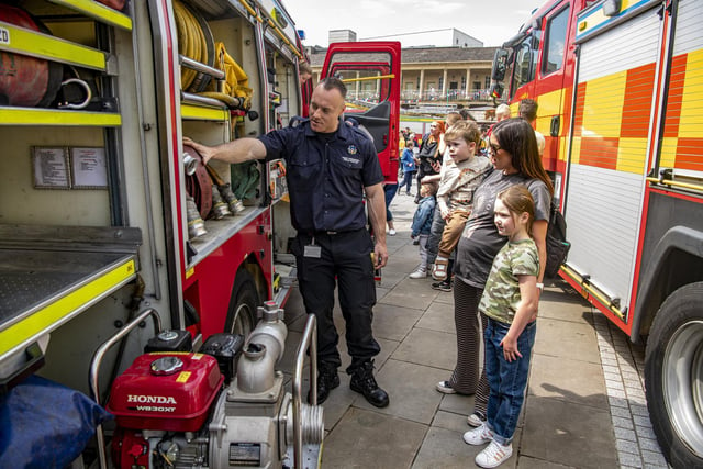 Rastrick firefighter Liam Redman with some of the visitors to The Piece Hall