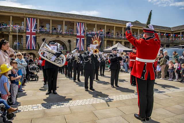 Bands from  West Yorkshire Fire Service and West Yorkshire Police march into The Piece Hall to perform the national anthem.