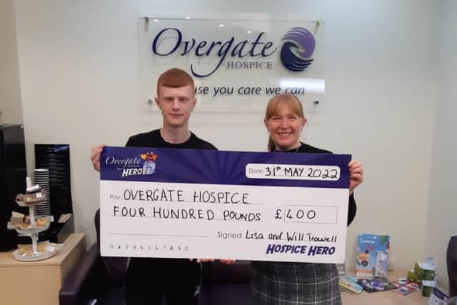 William Trowell with his mum, Lisa, and a cheque for the money he raised for Overgate Hospice. He also raised over £1,100 for Stand Up To Cancer
