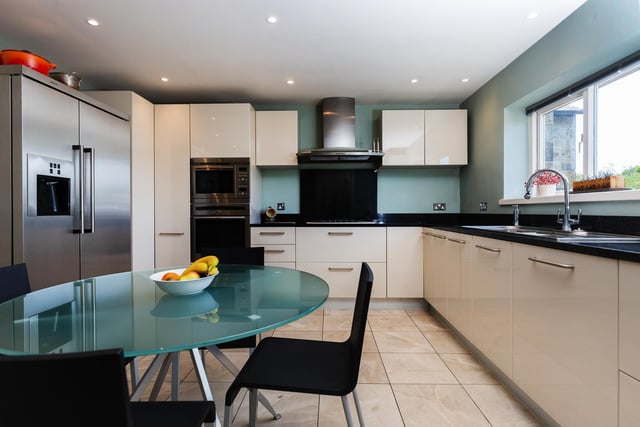 A sleek kitchen with fitted units and appliances.