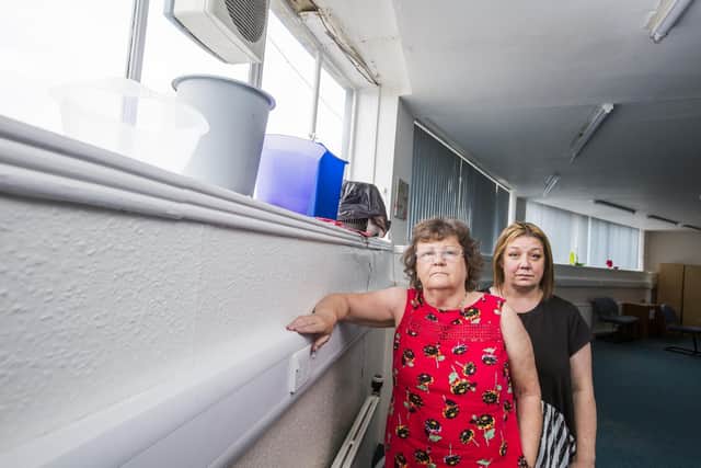 WomenCentre Calderdale and Kirklees Chief Executive Angela Everson and Communications Manager Maxine Edwards at the Halifax building where they have had to put buckets under the leaky windows