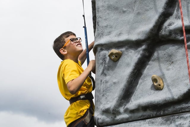 Riley Robertson, nine, tries out the climbing wall