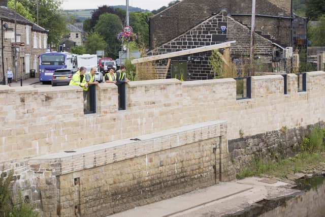 The wardens survey the river levels in Mytholmroyd