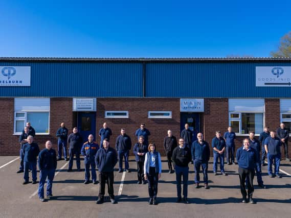 Chelburn Precision staff with managing director Neil Travis (front, with glasses) and his wife, Katie, who is also a director