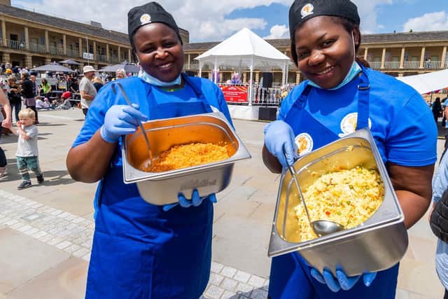 Fola Ifekoya and Amaka Akabuo, from Light Up Black & African Heritage Calderdale, serving food for the visitors
