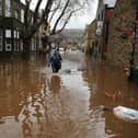 A  man wades through floodwaters as rivers burst their banks on December 26, 2015 in Hebden Bridge (Getty Images)