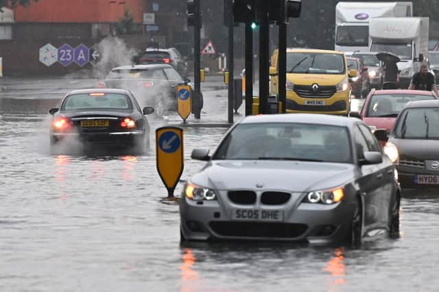 Buses and cars were left stranded when roads across London flooded last month, as repeated thunderstorms battered the British capital. (Photo by JUSTIN TALLIS/AFP via Getty Images)