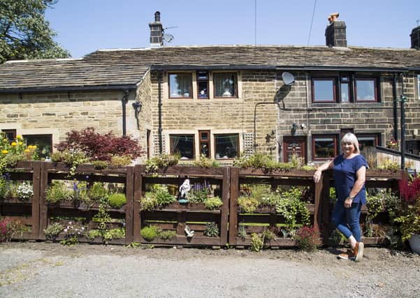 Sue Slater with the living wall outside her home in Heptonstall.