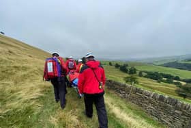 The woman was carried on a stretcher. Photo by Calder Valley Search and Rescue Team.
