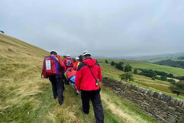 The woman was carried on a stretcher. Photo by Calder Valley Search and Rescue Team.