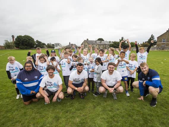 Children at the Try High holiday club, with front from left, Kara Colvin from Halifax Panthers Women, Aron Robinson from Calder Community Squash, Jack Duffy from Halifax Panthers, Danny Hutchinson from Invictus Well-being and Halifax Panthers player Dan Murray.