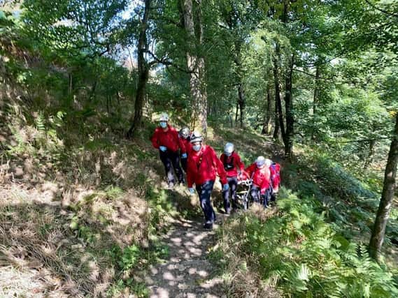 Calder Valley Search and Rescue Team carried the woman to a waiting ambulance.
