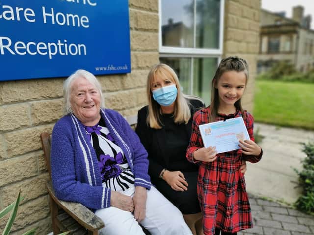 Pellon Care Centre. Resident Christine Craven and Home Manager Beverley Hanson present Macie with her prize