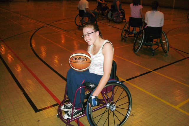 Hannah playing wheelchair basketball