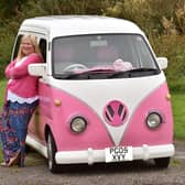 Janette Wilkinson with her pink camper van she has called Bagpuss - and a pink and white striped fluffy toy has pride of place on the dash board